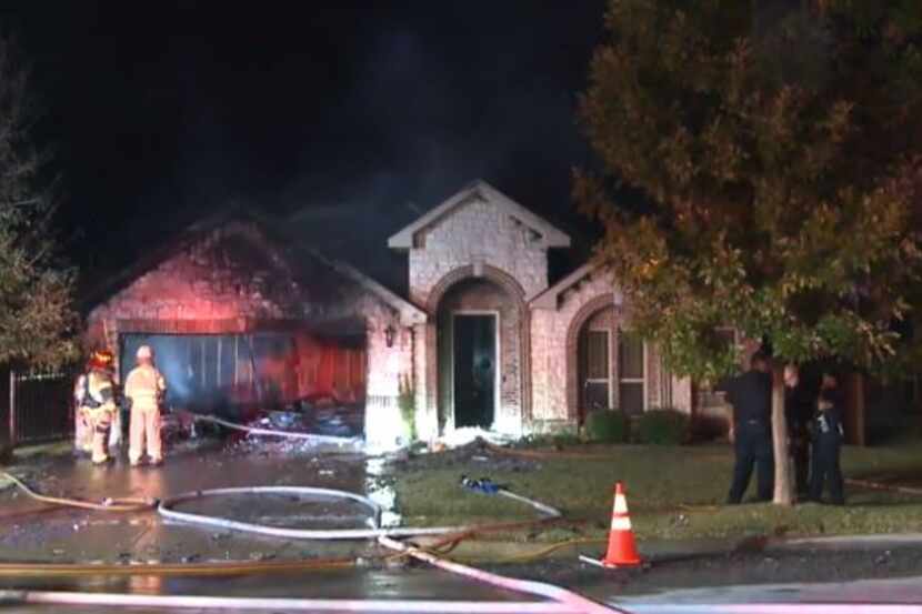 Mansfield firefighters take stock of a blaze that heavily damaged a home with an 11-year-old...