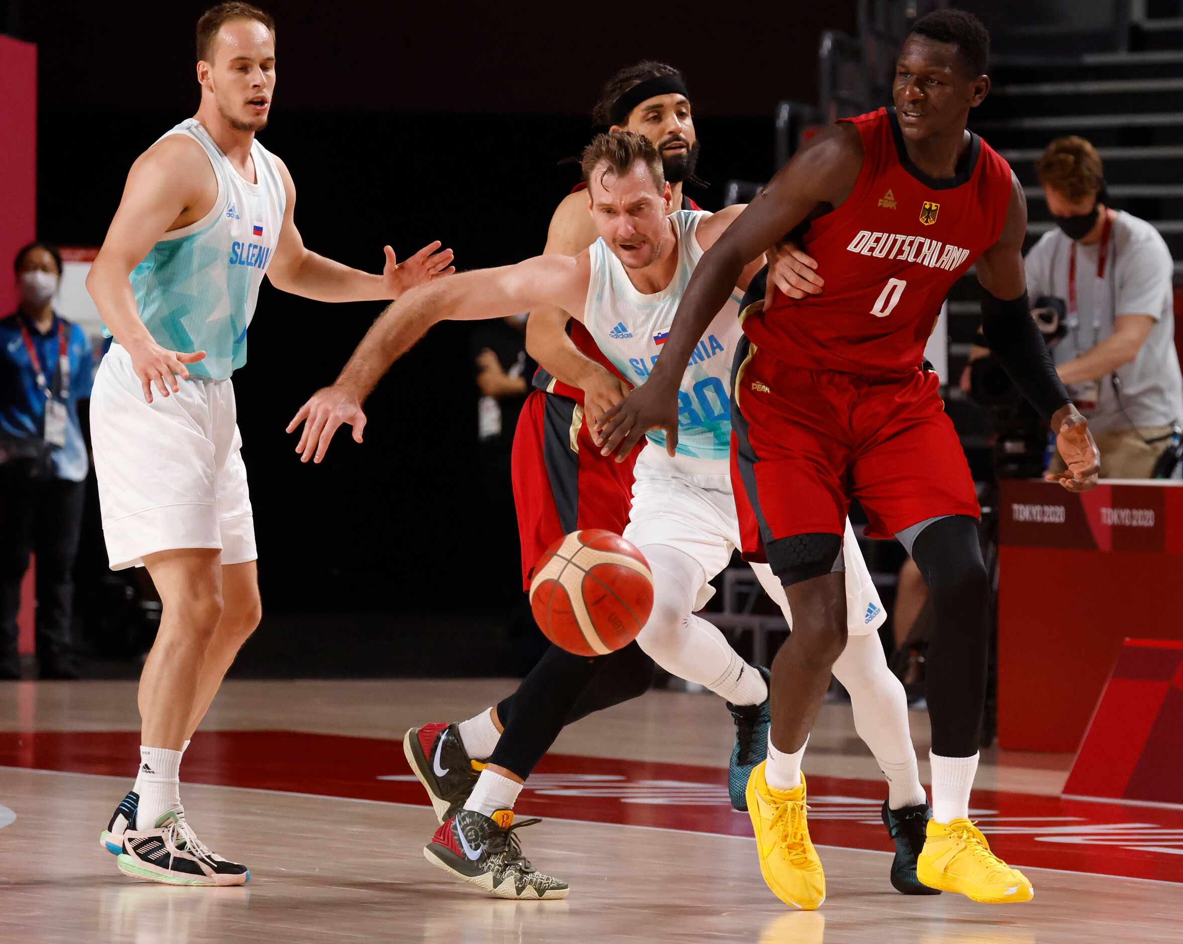 Slovenia’s Zoran Dragic (30) knocks the ball out of the hands of Germany’s Isaac Bonga (0)...
