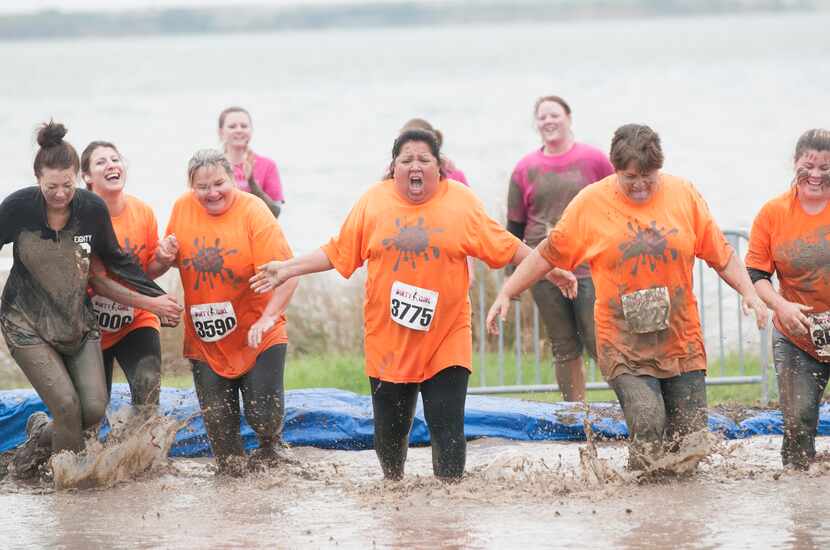Women competing in the Dirty Girl Mud Run at Cedar Hill State Park on Saturday, Oct. 6,...