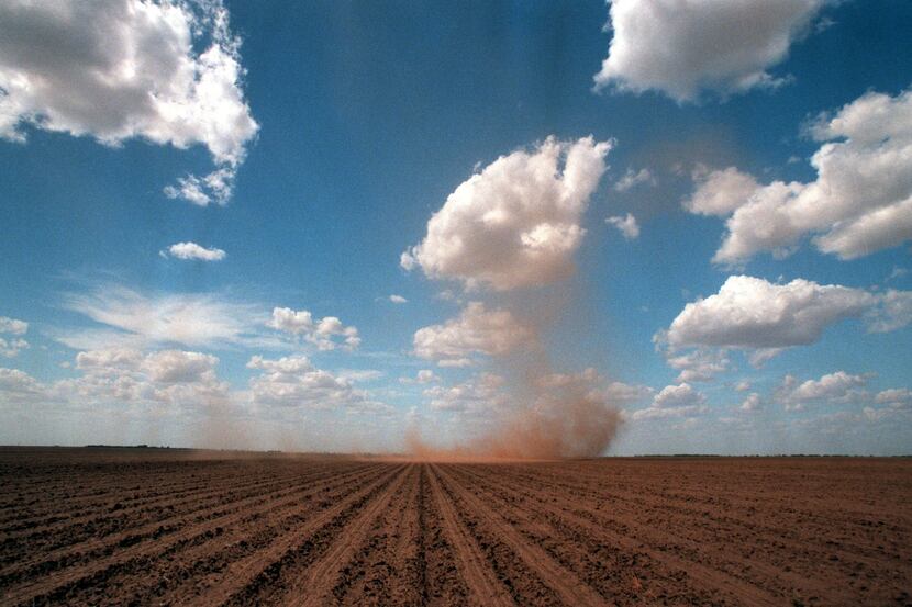 A dust devil rolls across a field near Sweetwater, an area commonly referred to by locals as...