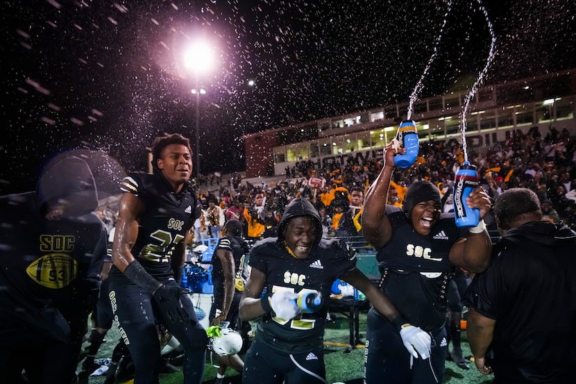 South Oak Cliff players, including defensive back Semaj'dre Gasaway (27) , defensive lineman...