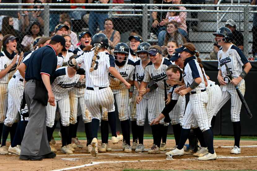Flower Mound players wait at home plate to celebrate with McKenna Andrews (8) after her...