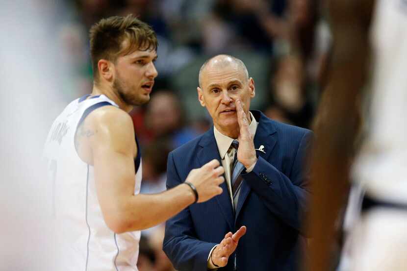 Dallas Mavericks head coach Rick Carlisle talks with Dallas Mavericks guard Luka Doncic (77)...