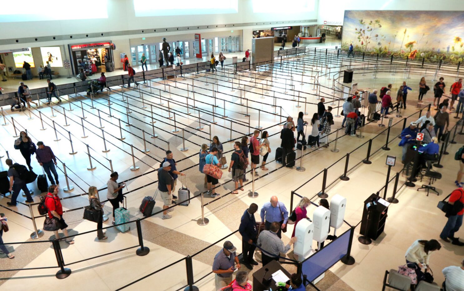 Passengers wait in line at a security checkpoint at Dallas Love Field on Oct. 19, 2017. 