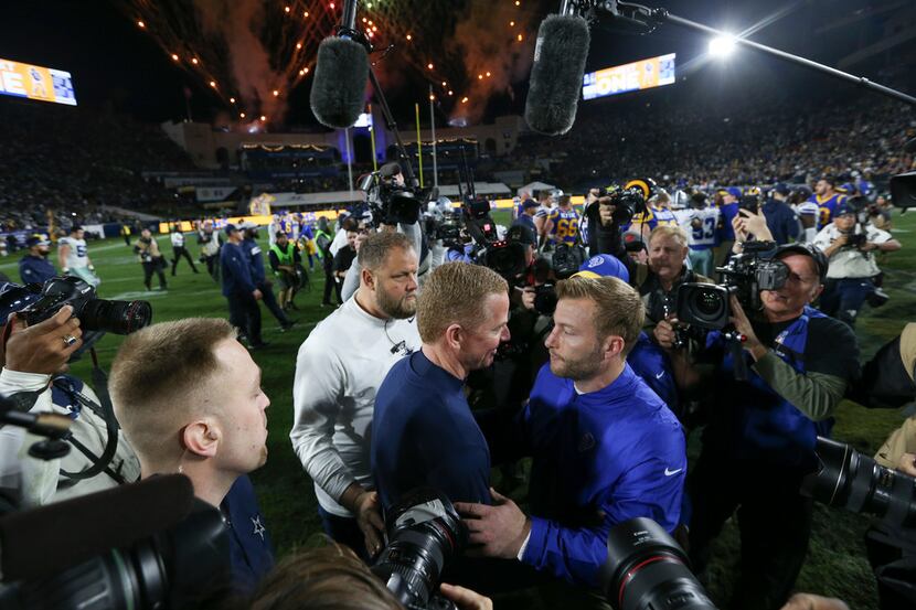 Dallas Cowboys head coach Jason Garrett, left, embraces Los Angeles Rams head coach Sean...