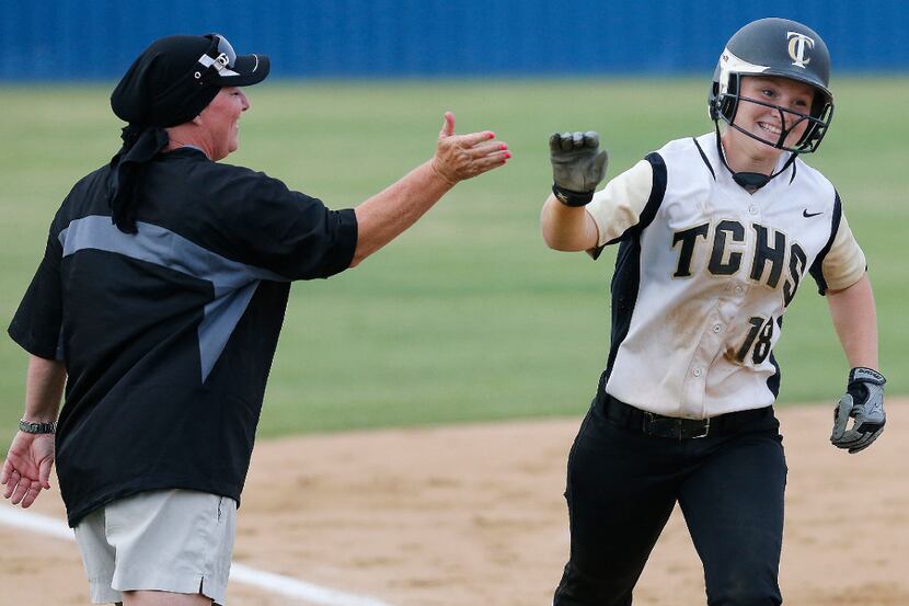 The Colony third baseman Madison Hirsch (18) is congratulated by her head coach, Deana...