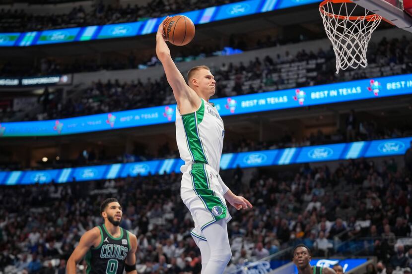 Dallas Mavericks center Kristaps Porzingis (6) dunks the ball past Boston Celtics forward...