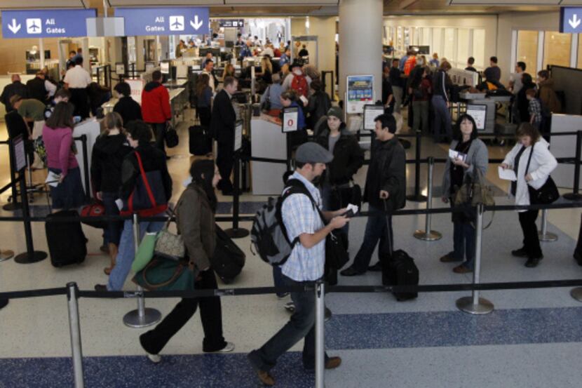 Travelers jammed a security checkpoint Tuesday at Dallas/Fort Worth International Airport's...
