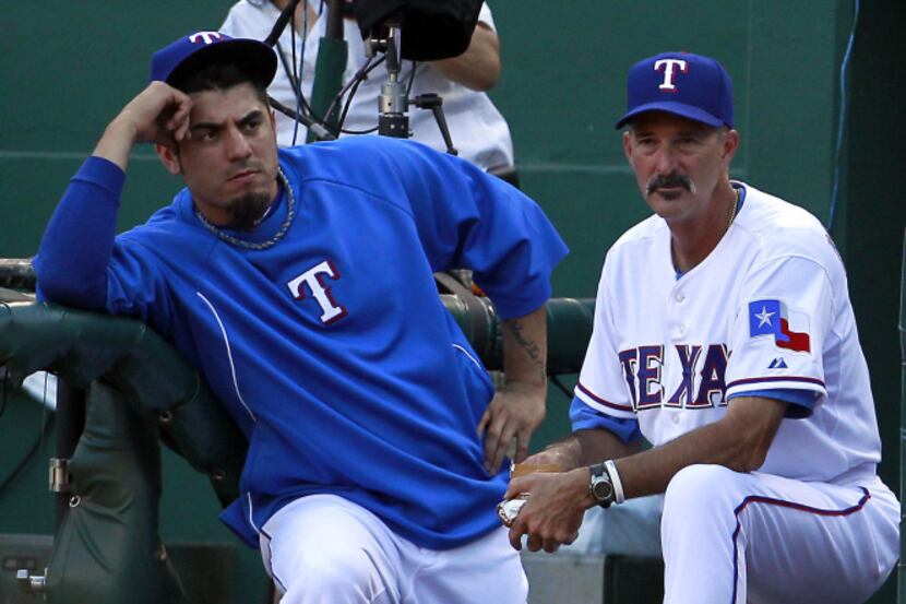 Texas Rangers pitcher Matt Garza (22) with Texas Rangers pitching coach Mike Maddux (31)...