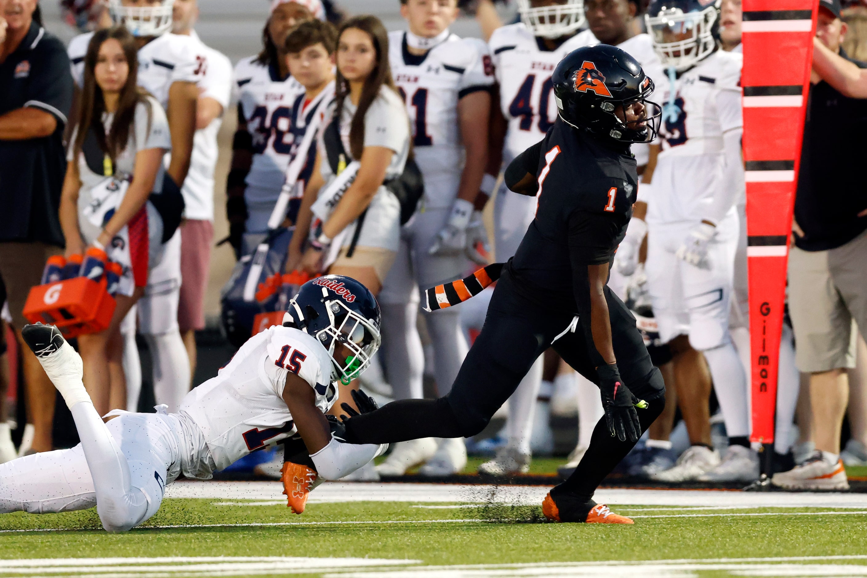 Denton Ryan defensive back Xaier Hiler (15) tackles Aledo running back Raycine Guillory Jr....