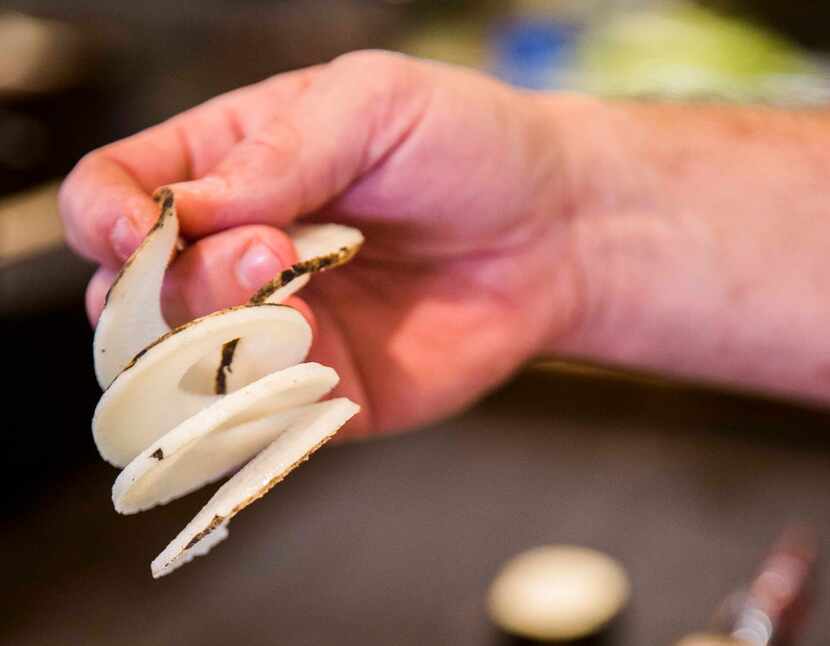 Chef Graham Dodds holds a piece of spiralized radish on Thursday, March 31, 2016 at Wayward...