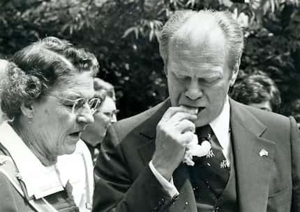 President Gerald Ford tries to eat a tamale without removing the husk during a campaign stop...