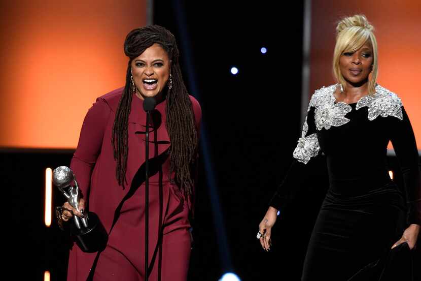Director Ava DuVernay, left, accepts the award for the entertainer of the year as Golden...