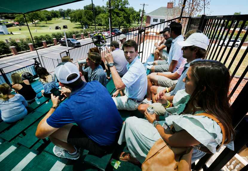 Jeff Wilhelm (center) turns to visit with Maddy Conklin (right) as they watched the third...