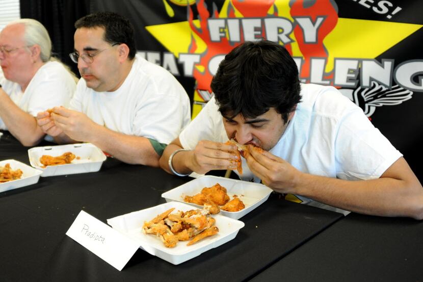 Pradipta Chattejee chows down on wings by Wing Town at the Taste of Irving Fiery Heat...