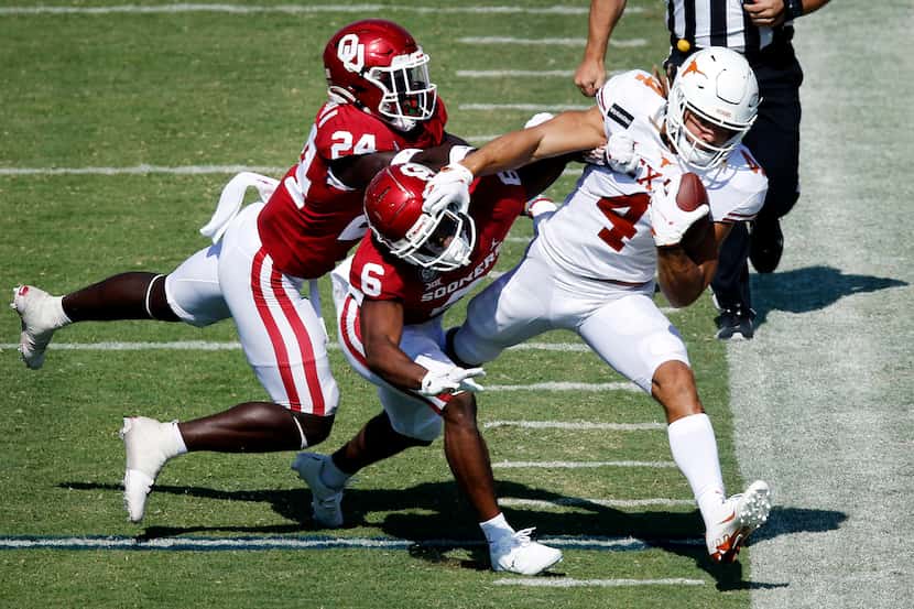 Texas Longhorns wide receiver Jordan Whittington (4) is forced out of bounds by Oklahoma...