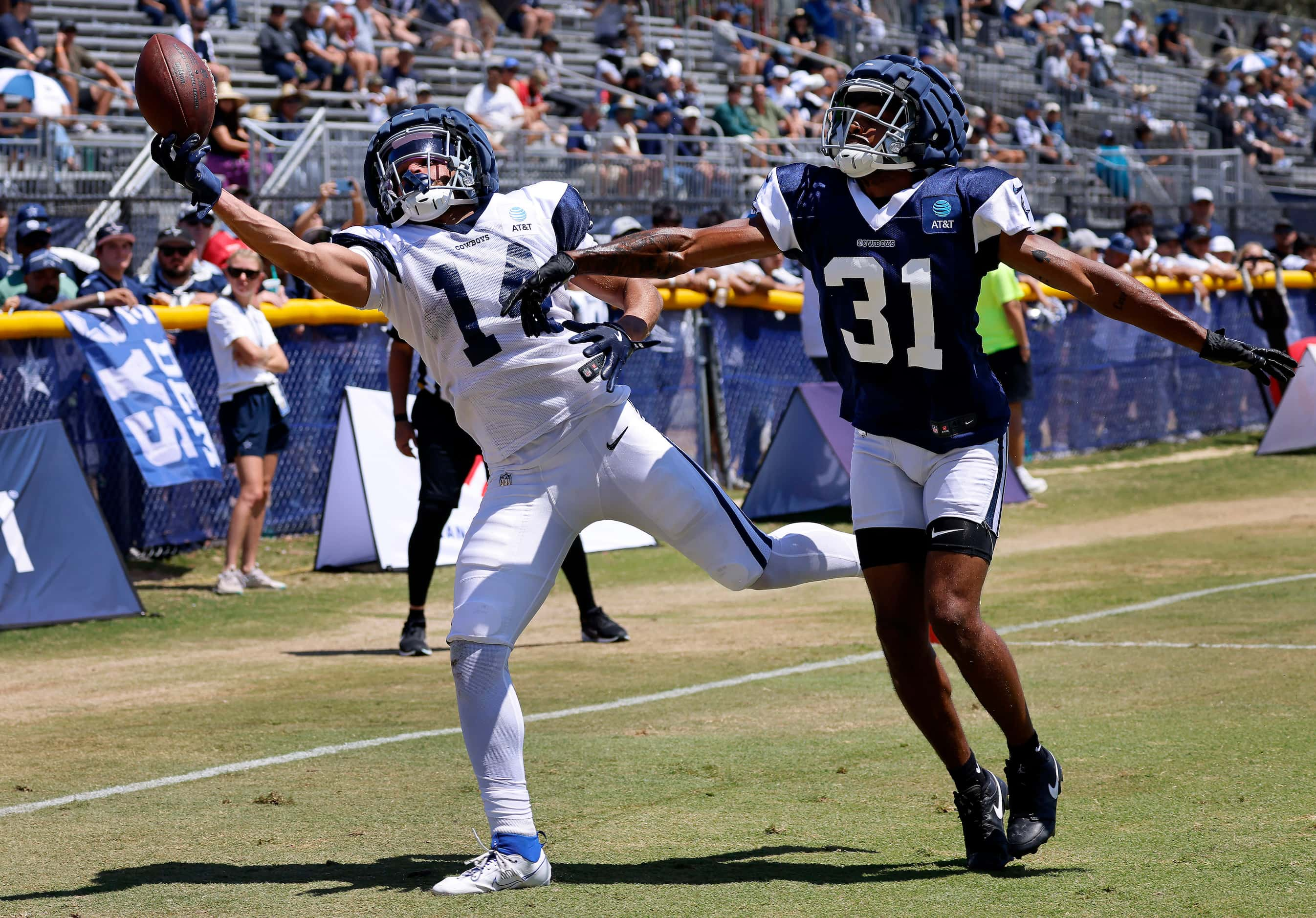 Dallas Cowboys wide receiver Cam Johnson (14) reaches in vein for a touchdown catch as he’s...