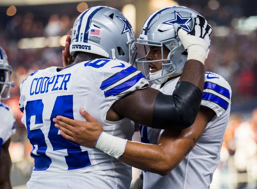 Dallas Cowboys quarterback Dak Prescott (4) celebrates a touchdown with offensive guard...