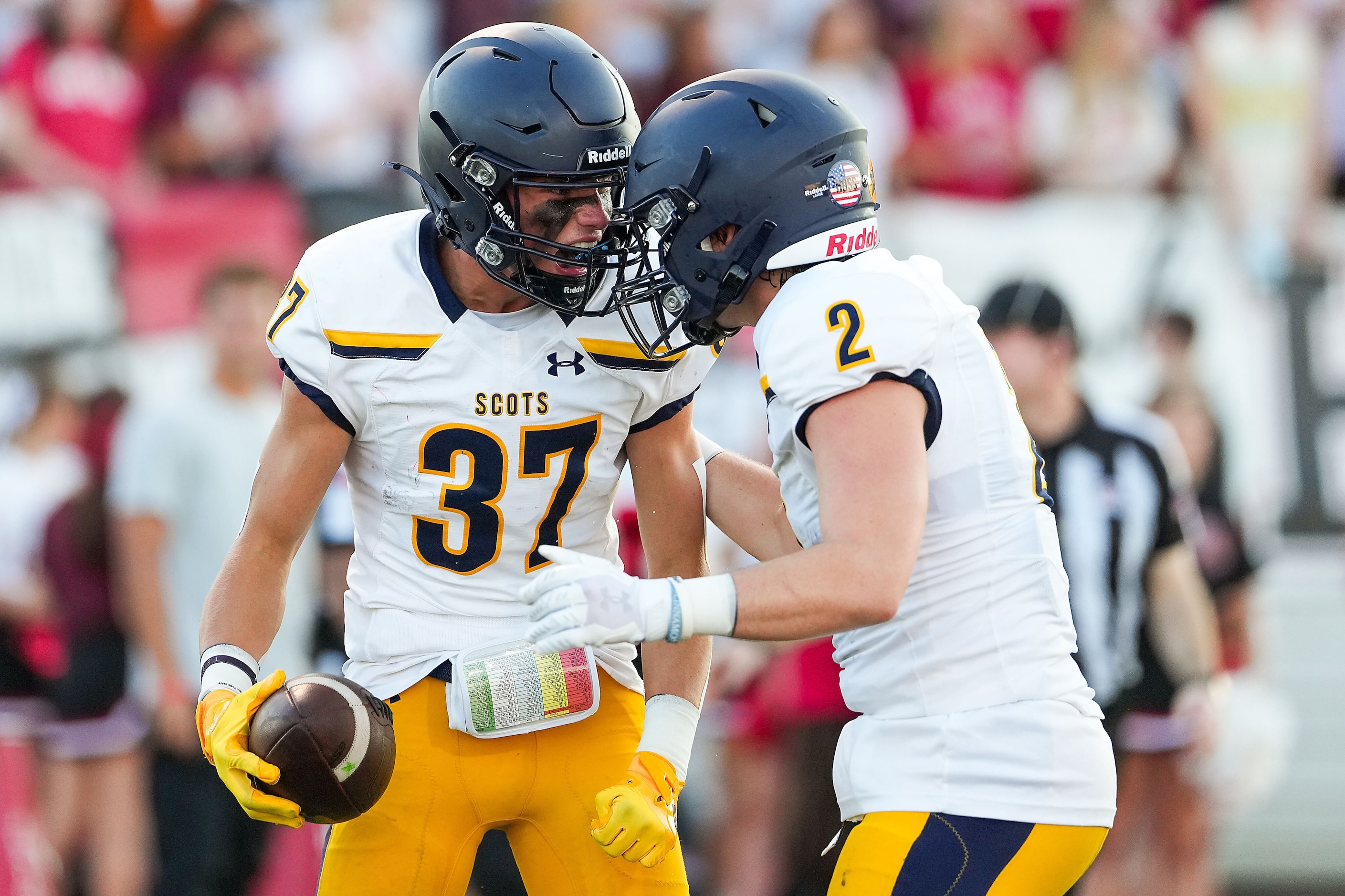 Highland Park wide receiver Cannon Bozman (37) celebrates with Paxton Smith (2) after...