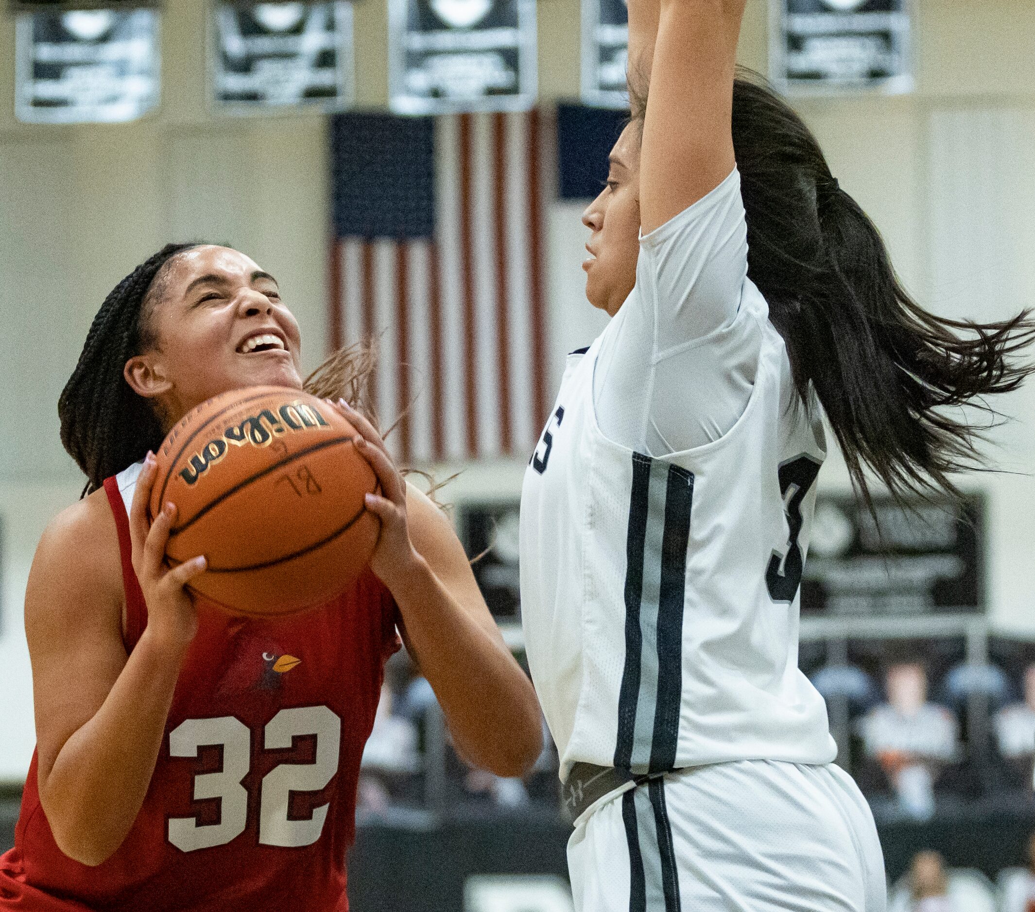 John Paul II High School Allysia McDaniel (32) bends her knees before jumping to shoot the...