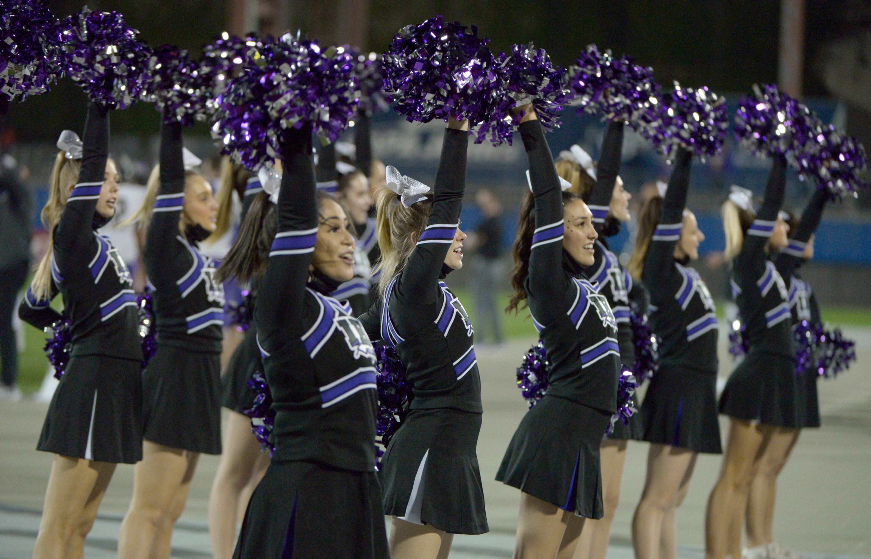 Members of the Frisco Independence cheer squad perform in the first quarter of a high school...
