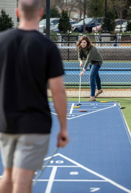 Kyle and Kaitlyn Tatum play a game of shuffleboard outside Standard Service in Heath.