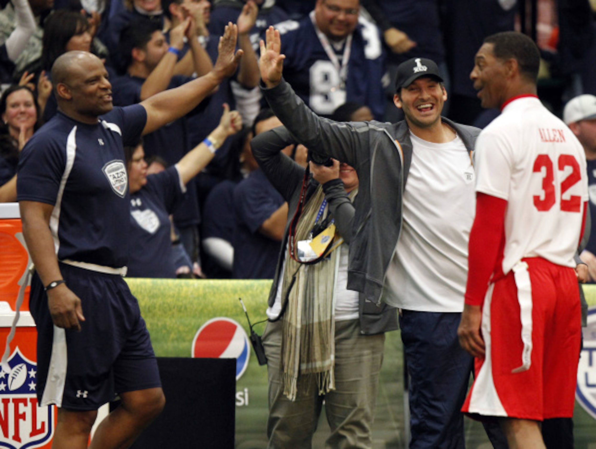 AFC's Marcus Allen (32) reacts as NFC's Warren Moon (1) and head coach Tony Romo celebrate a...