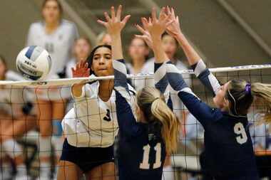 Keller middle blocker Leah Ford (9) hits the ball past the attempted block of Northwest...
