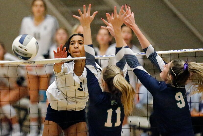 Keller High School middle blocker Leah Ford (9) hits the ball past V.R. Eaton High School...