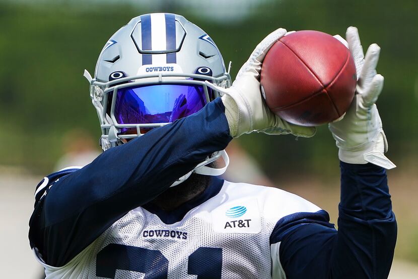 Dallas Cowboys running back Ezekiel Elliott catches a pass during a minicamp practice at The...