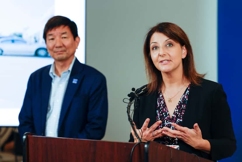 Director of Dallas County Health and Human Services, Philip Huang (left), listens to Centers...