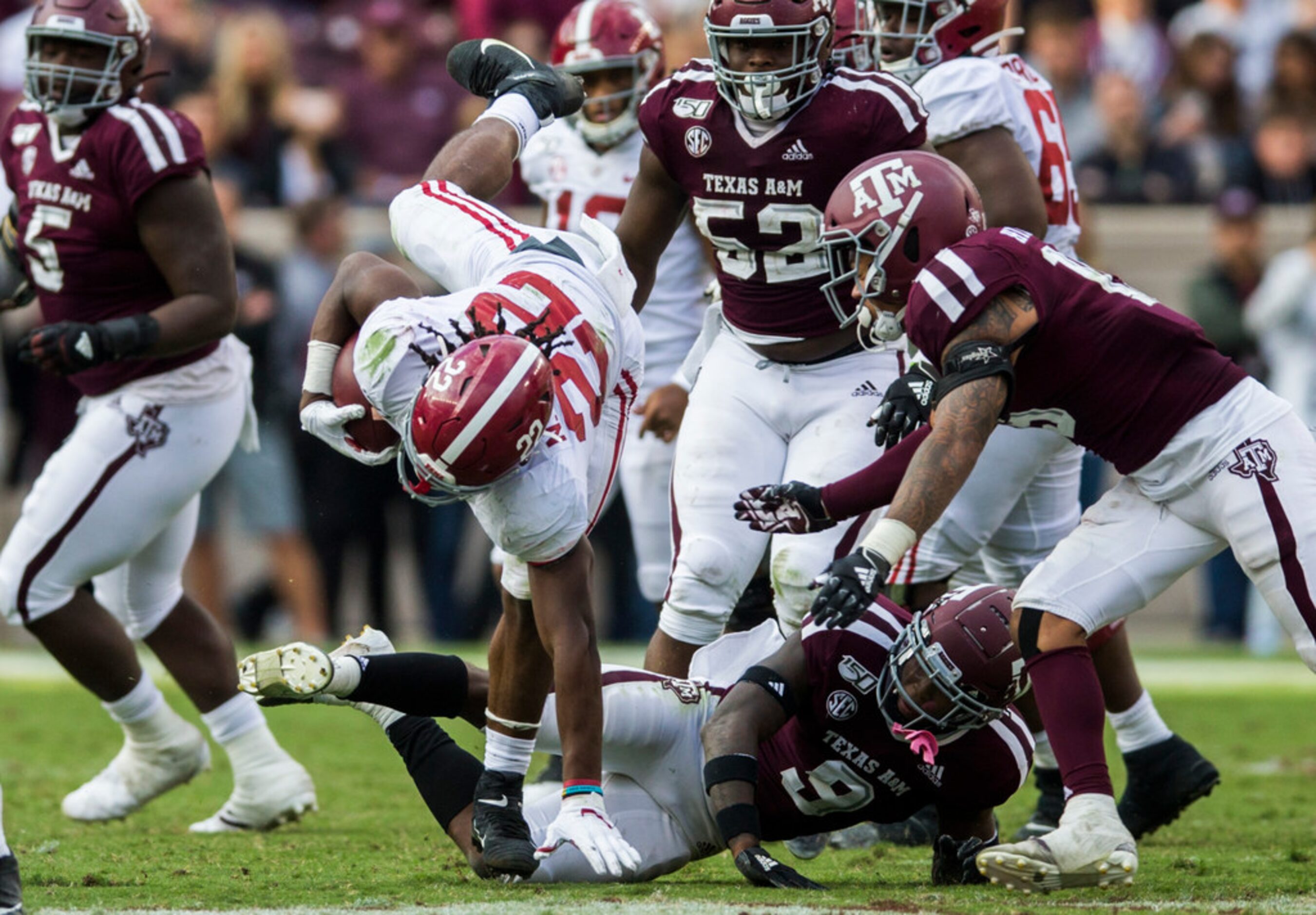 Alabama Crimson Tide running back Najee Harris (22) is launched in the air after a tackle by...