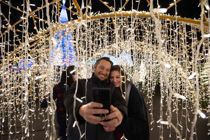 Fred Azmy and Hana Azmy of Forney use their camera phone for a selfie while passing through...