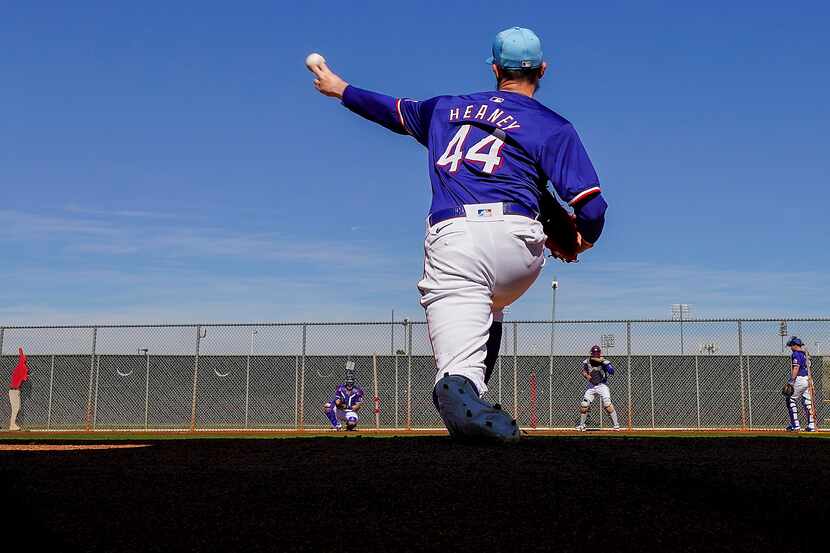 Texas Rangers pitcher Andrew Heaney throws in the bullpen during a spring training workout...