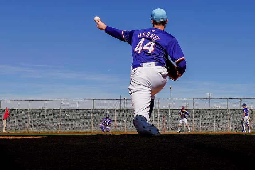 Texas Rangers pitcher Andrew Heaney throws in the bullpen during a spring training workout...