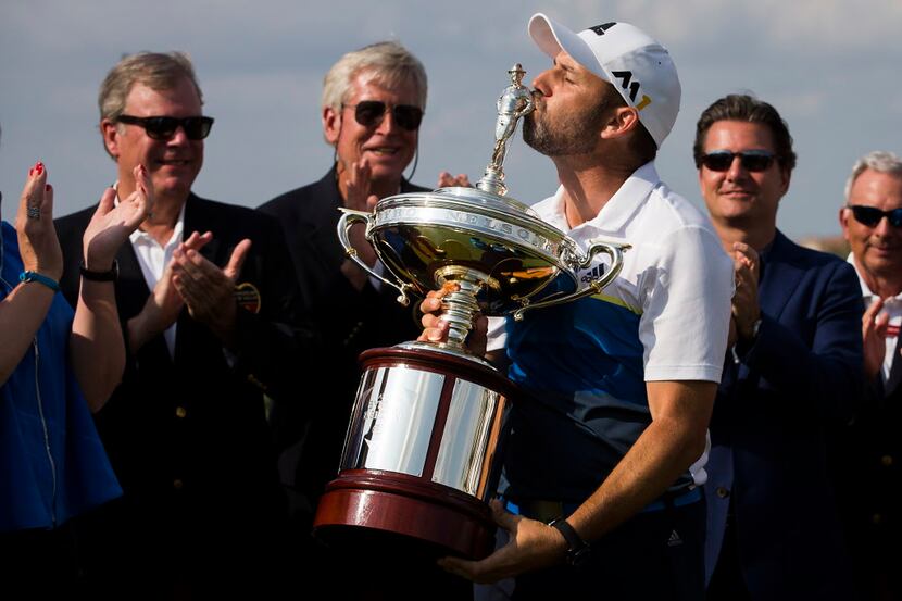 Sergio Garcia of Spain kisses the figure of Byron Nelson atop the championship trophy after...