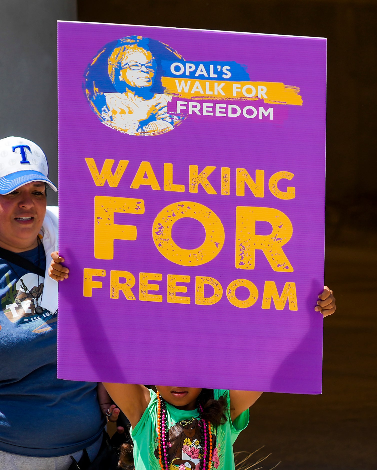 A youngster holds a sign during the 2022 Opal's Walk for Freedom on Saturday, June 18, 2022,...