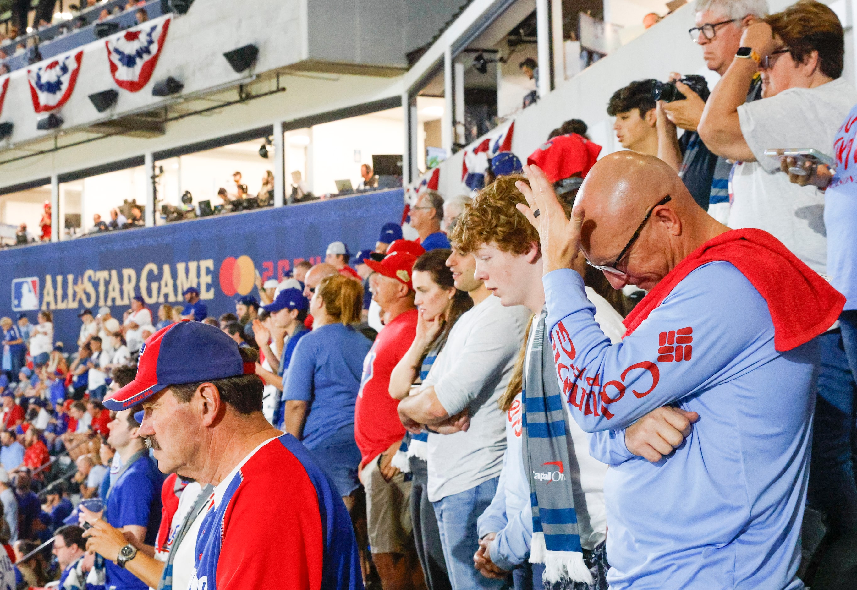 Fans reacts as the Texas Rangers stranded two runners during the eighth inning while...