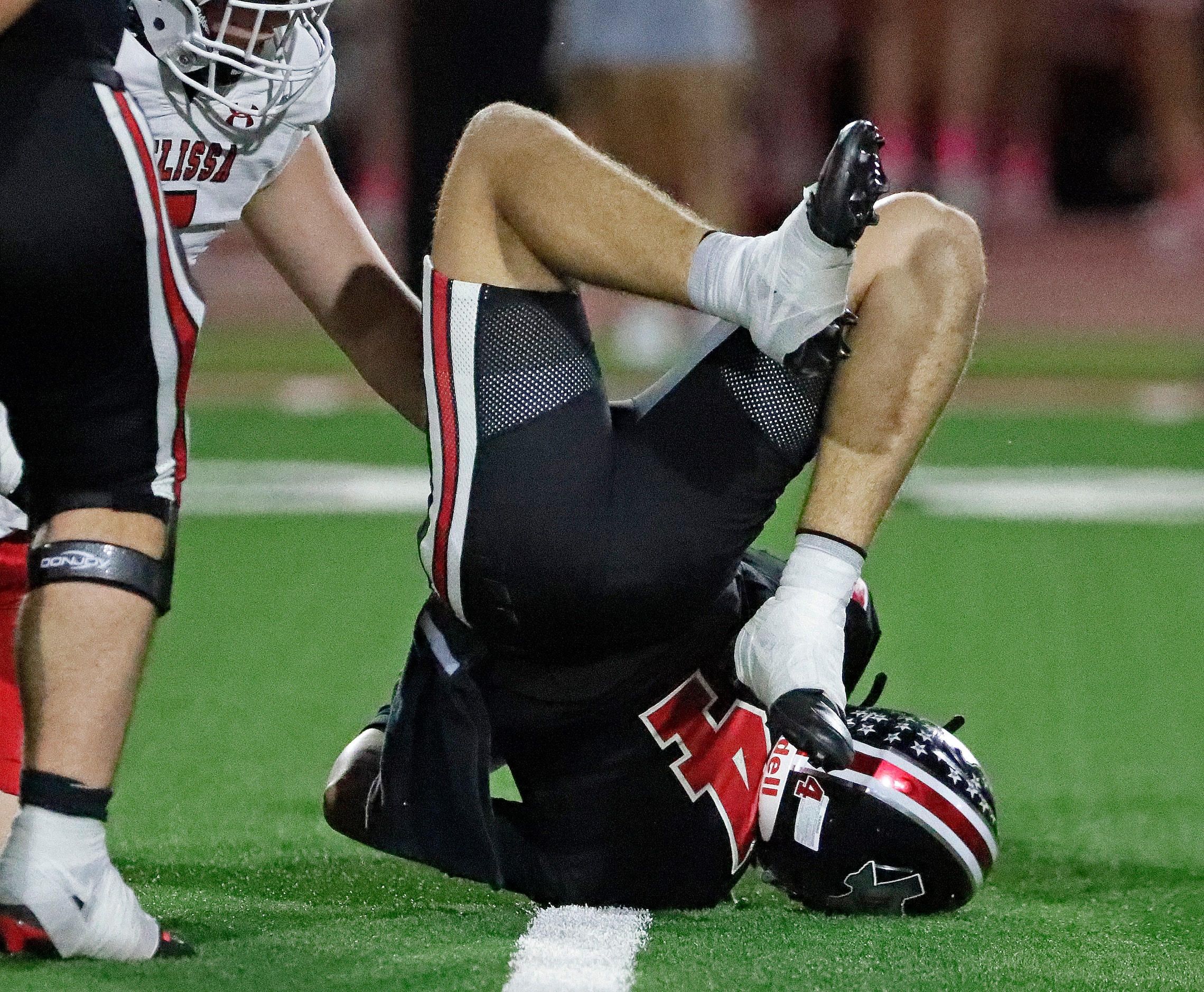 Melissa High School defensive lineman Jacob Wasserman (5) gets a sack as Lovejoy High School...