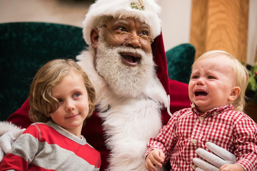 Santa Larry Jefferson smiles with Auden Good, 4, and his one-year-old brother Ezra of Ramsey...