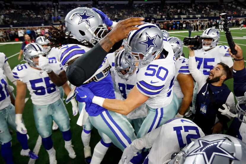 Dallas Cowboys middle linebacker Jaylon Smith (54) smashes helmets with outside linebacker...