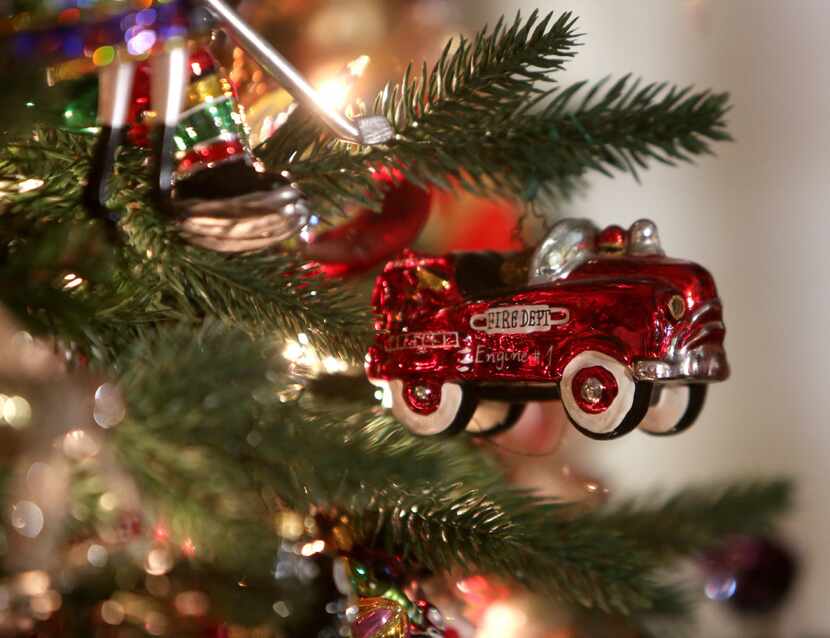 A fire engine ornament hangs on the tree.