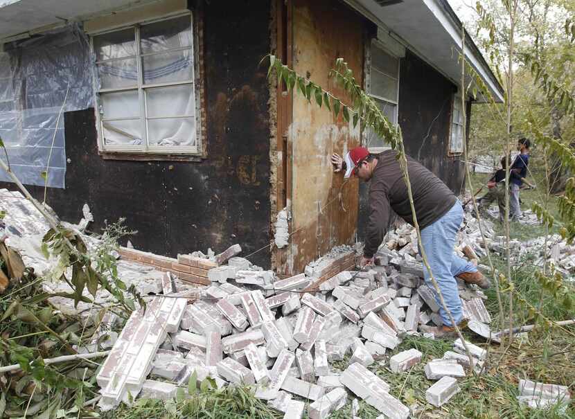 
Chad Devereaux cleaned up bricks after two earthquakes struck in Sparks, Okla., in November...