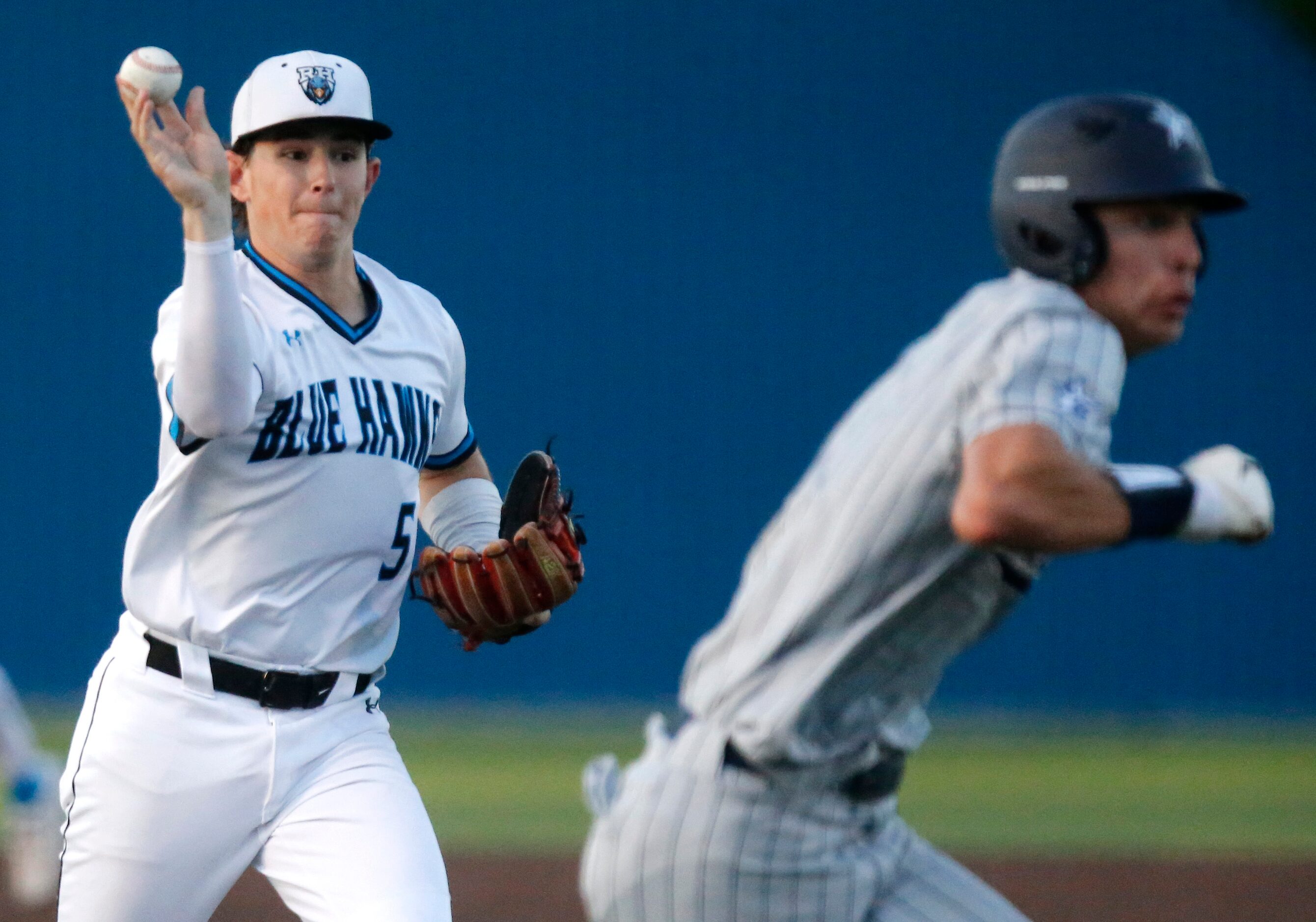 Rock Hill High School third baseman Jacob Mercer (5) makes a throw as Lone Star High School...