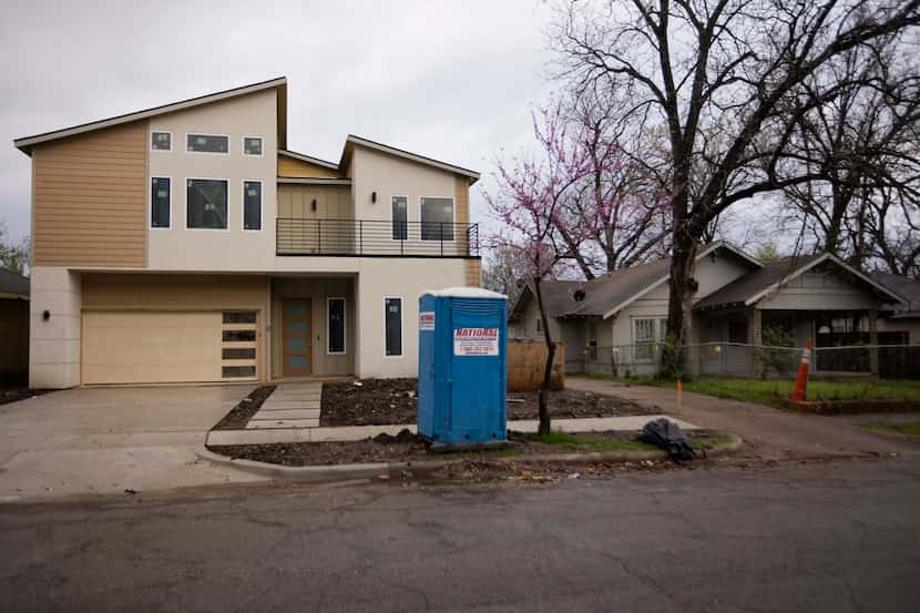 A newly constructed home photographed next to a single-story home in Old East Dallas on...