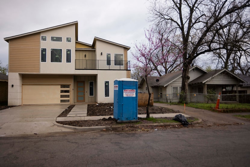 A newly constructed home photographed next to a single-story home in Old East Dallas on...