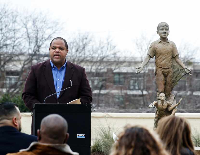 Dallas Mayor Eric Johnson speaks to the crowd in front of the sculpture celebrating the life...