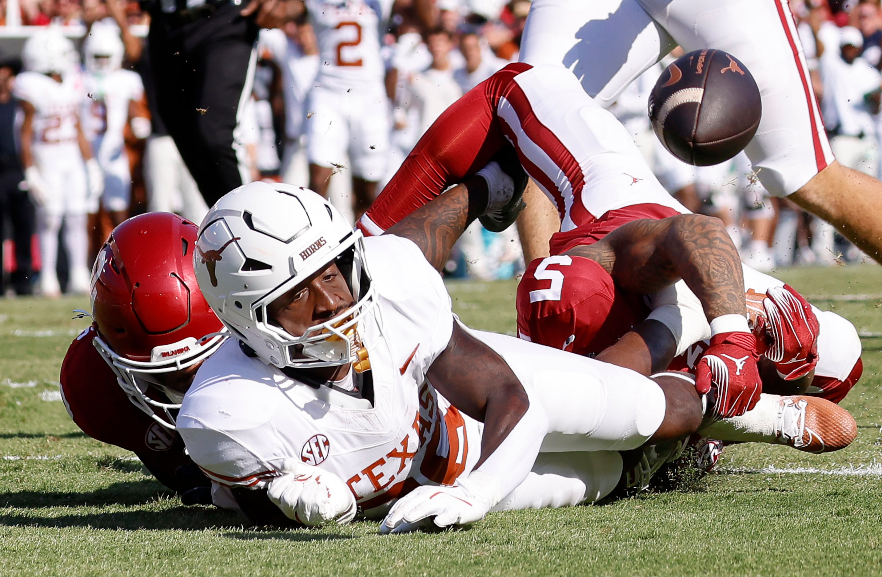 Despite the fumble by Texas Longhorns running back Quintrevion Wisner (26), teammate Silas...