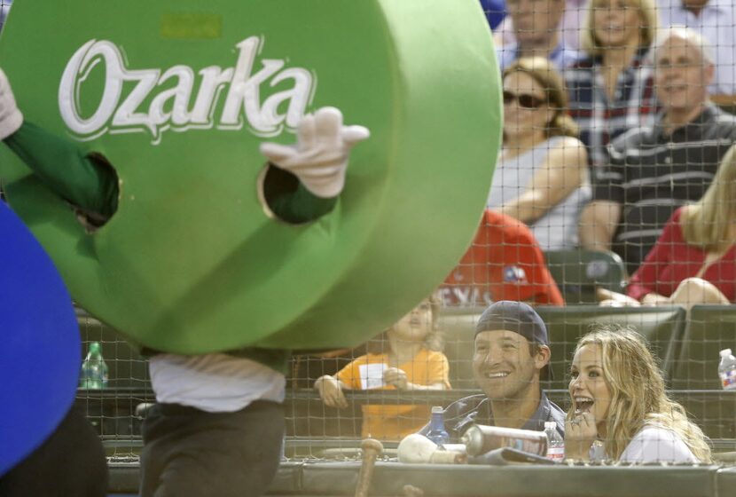 Dallas Cowboys quarterback Tony Romo and wife Candice Romo laugh as the dots collide while...