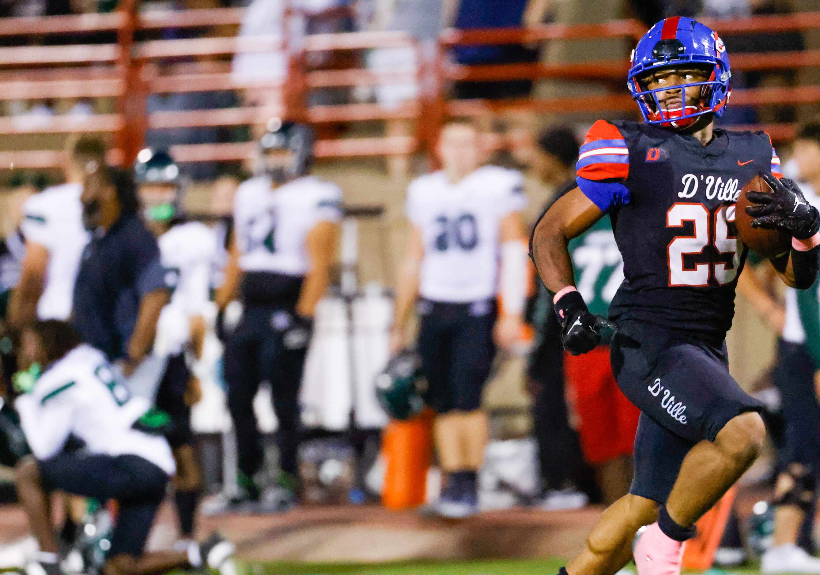 Duncanville running back Caden Durham (29) looks behind him as he carries the ball down the...